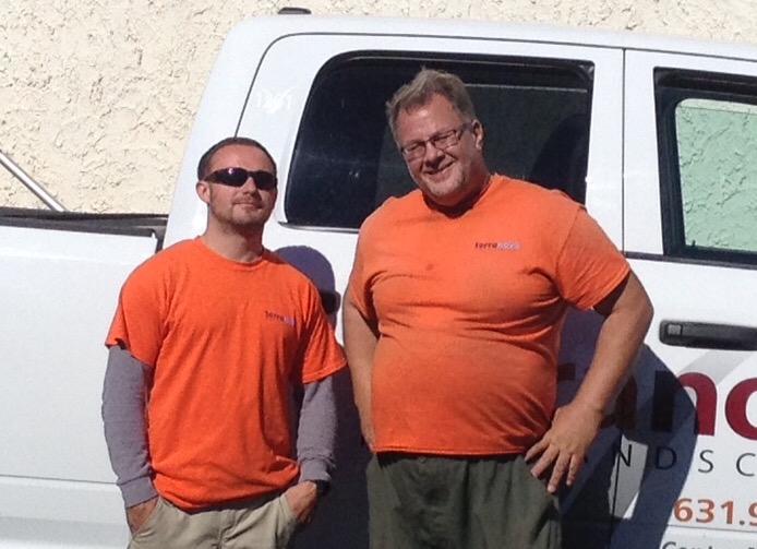 Two Terranova coworkers smiling beside a truck